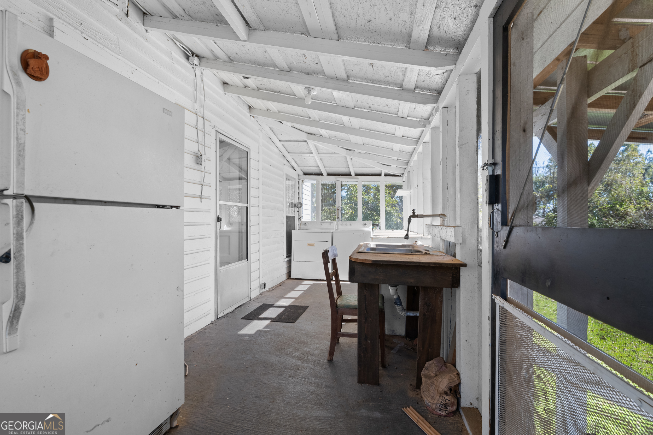 2 Finch Street Portal, GA 30450 - Photo 20 of 23 a kitchen with refrigerator and chairs