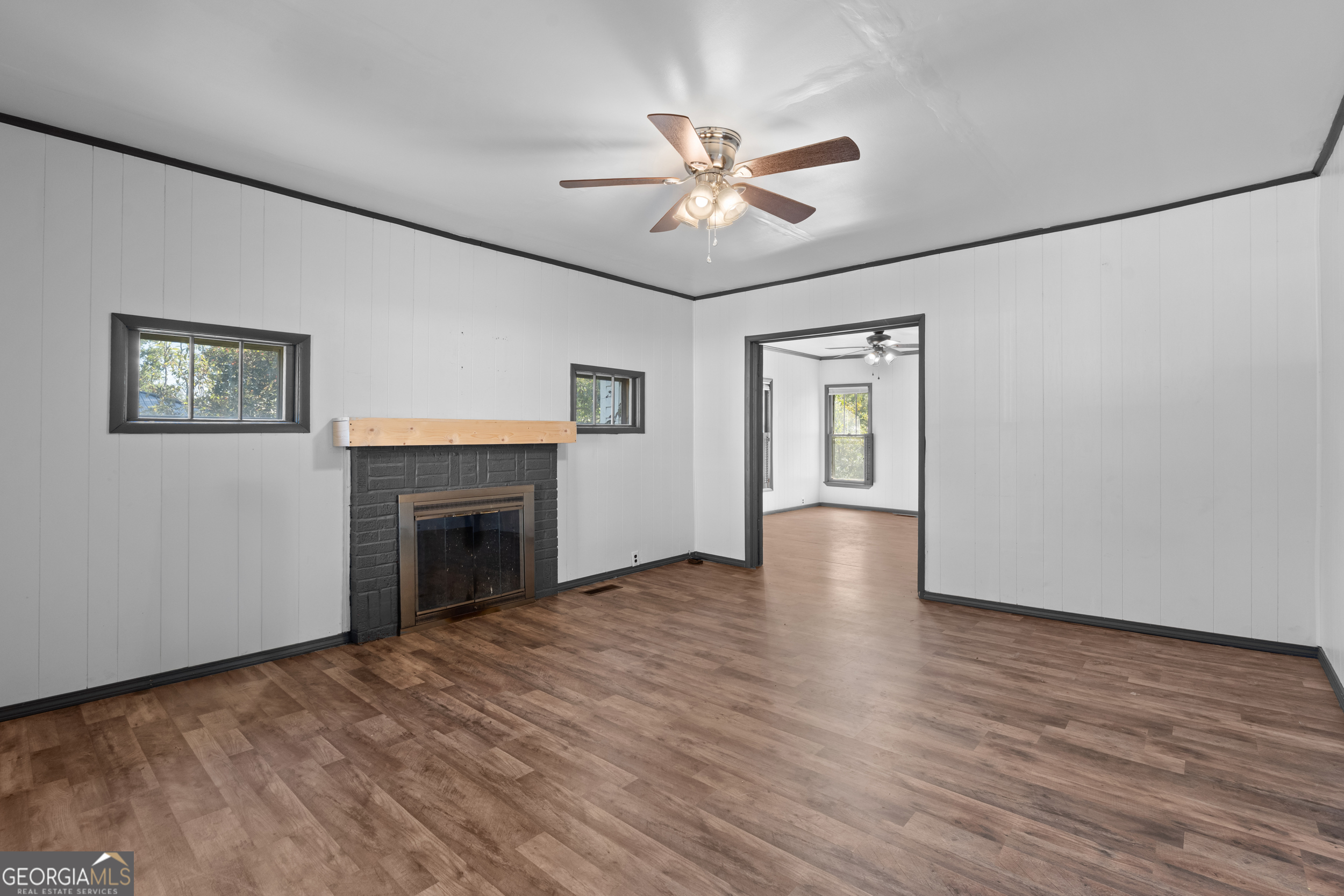 2 Finch Street Portal, GA 30450 - Photo 3 of 23 a view of an empty room with wooden floor and a fireplace