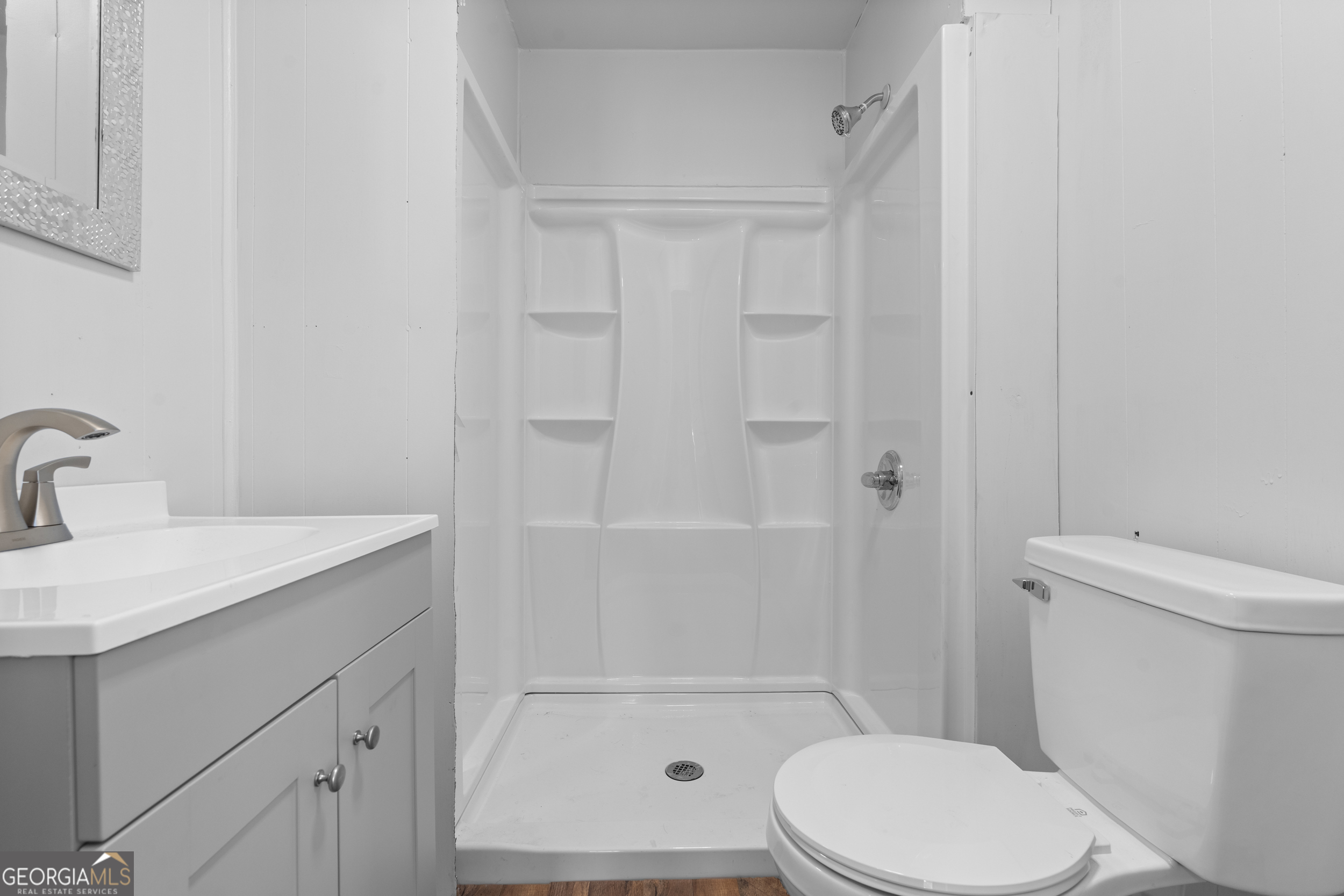2 Finch Street Portal, GA 30450 - Photo 10 of 23 a white toilet sitting next to a bathroom sink