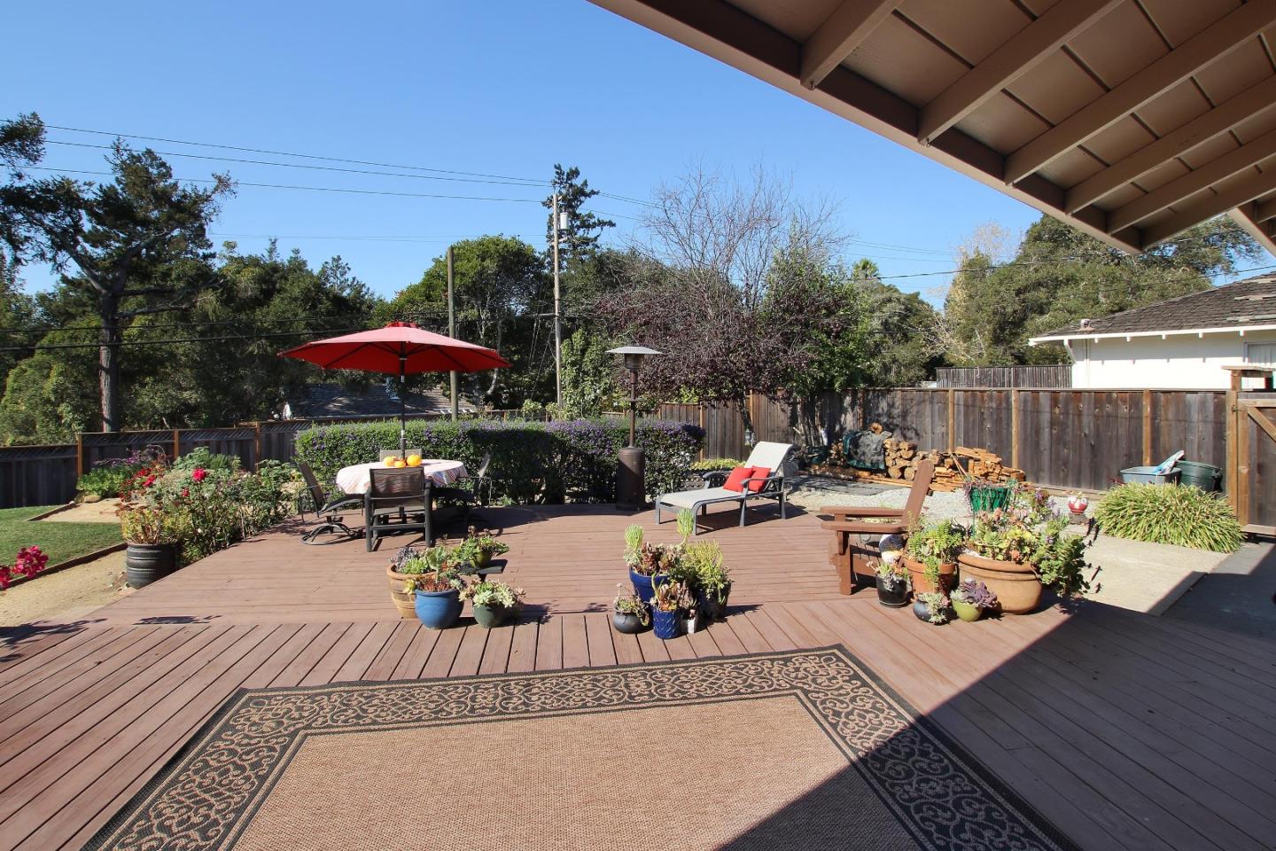 11 Oak Road Santa Cruz, CA 95060 - Photo 42 of 57 a view of a patio with couches table and chairs under an umbrella with a barbeque