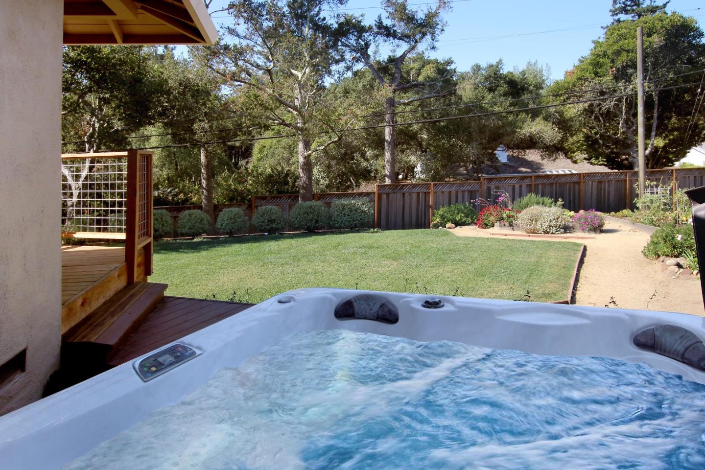 11 Oak Road Santa Cruz, CA 95060 - Photo 43 of 57 a view of a backyard with lawn chairs potted plants and a palm tree