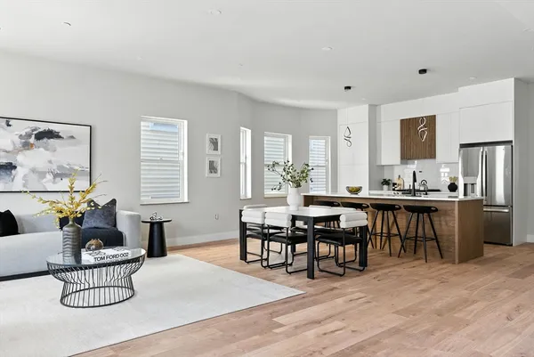 a living room with furniture kitchen view and a dining table