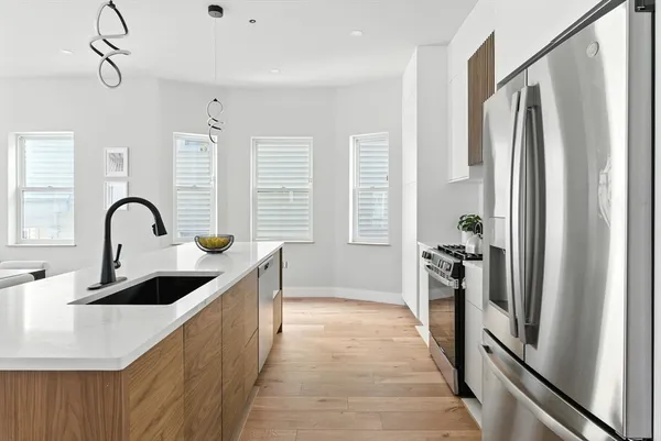 a kitchen with refrigerator a sink and cabinets