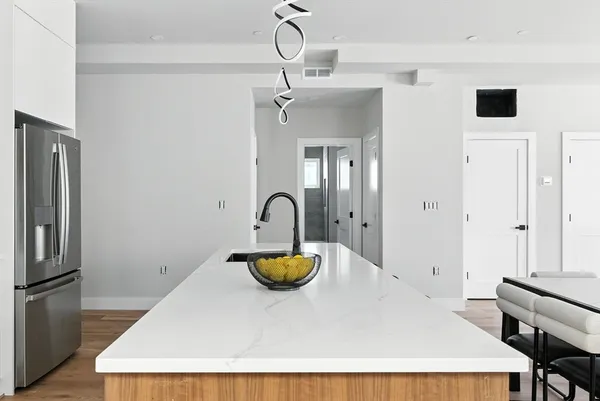 a kitchen with a refrigerator and a table