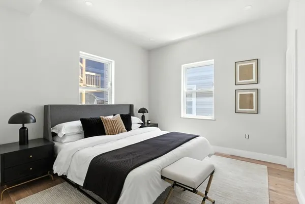 a bedroom with a bed and wooden floor