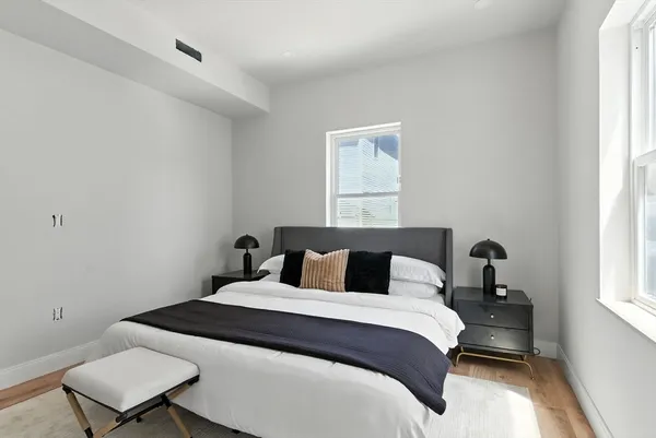 a bedroom with a bed and a window
