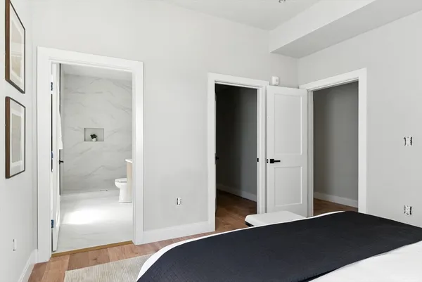 an empty room with wooden floor and mirror