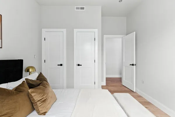 a bedroom with a bed and a mirror