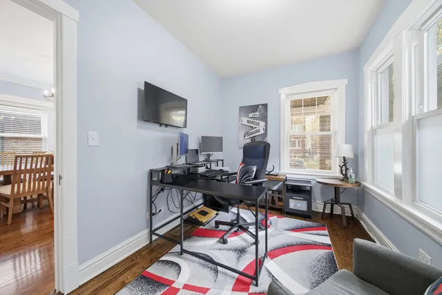 a view of a workspace with furniture and a window
