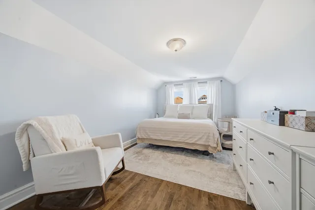 a bedroom with a bed and a chair