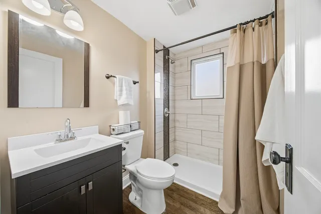 a bathroom with a sink toilet and shower