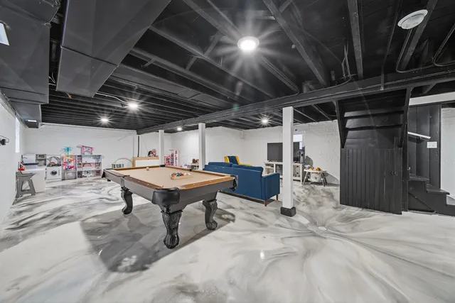 a roof deck with table and chairs