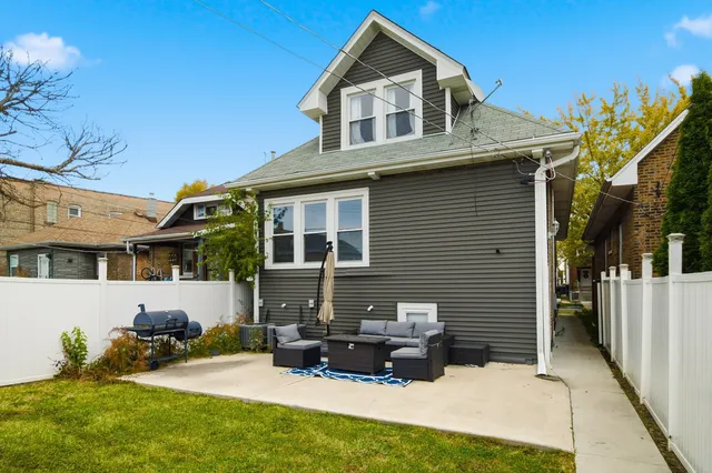 a backyard of a house with yard fire pit and outdoor seating
