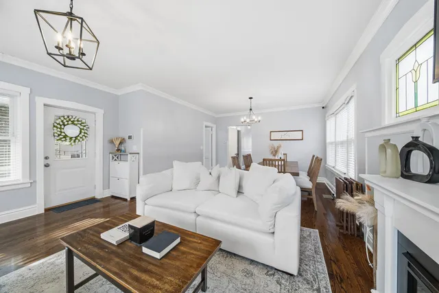 a living room with furniture a fireplace and a window