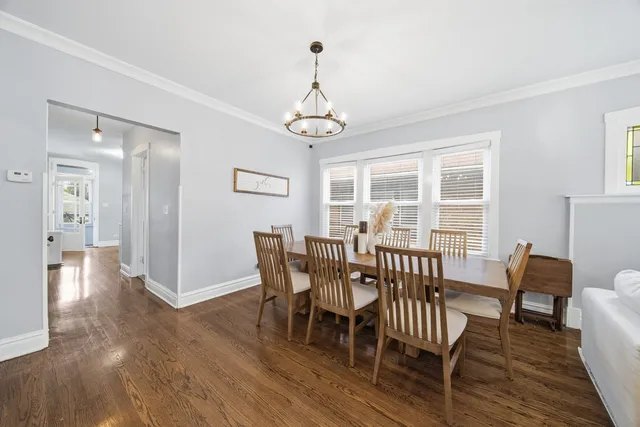 a view of a dining room with furniture wooden floor and chandelier