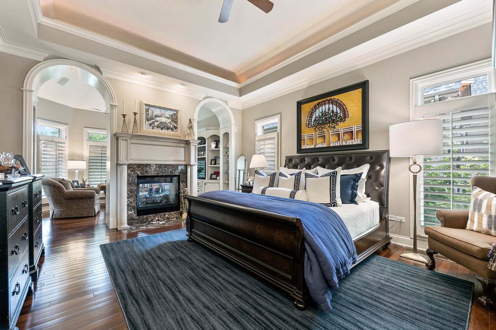 992 Sylvan Circle Naperville, IL 60540 - Photo 16 of 36 a spacious bedroom with a bed a couch and wooden floor