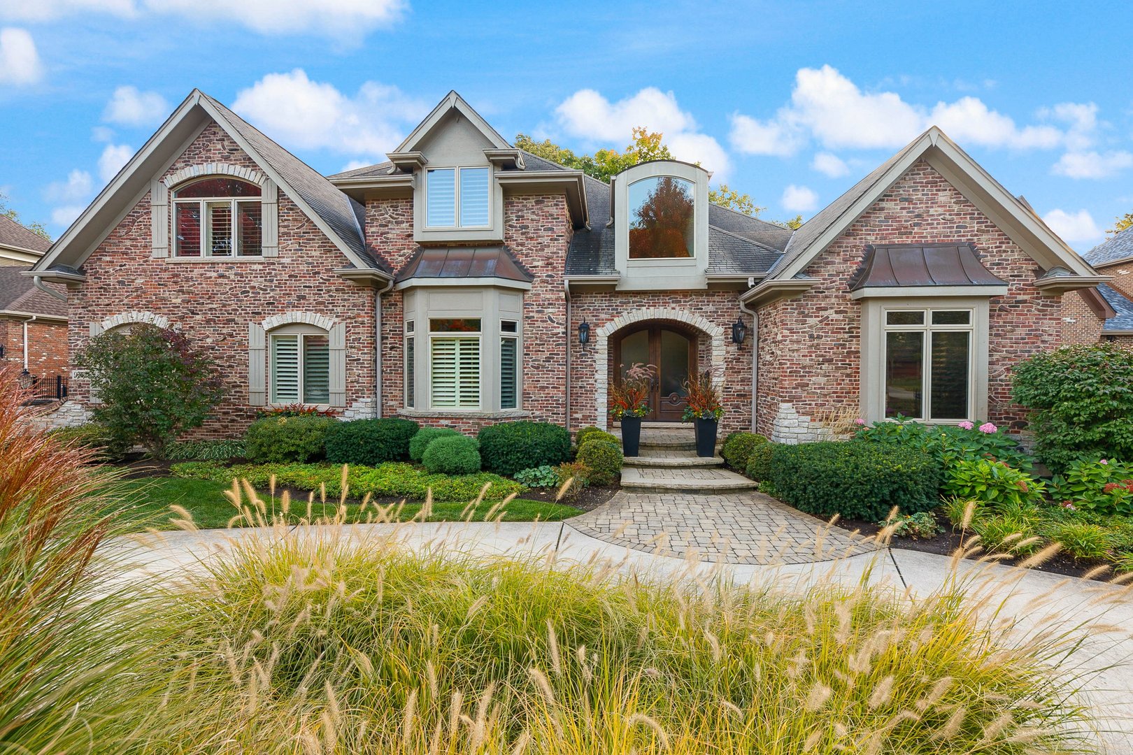 992 Sylvan Circle Naperville, IL 60540 - Photo 34 of 36 a front view of a house with a yard and potted plants