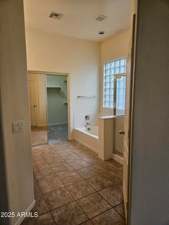 a bathroom with a bathtub sink and mirror