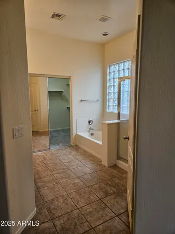 a bathroom with a bathtub sink and mirror
