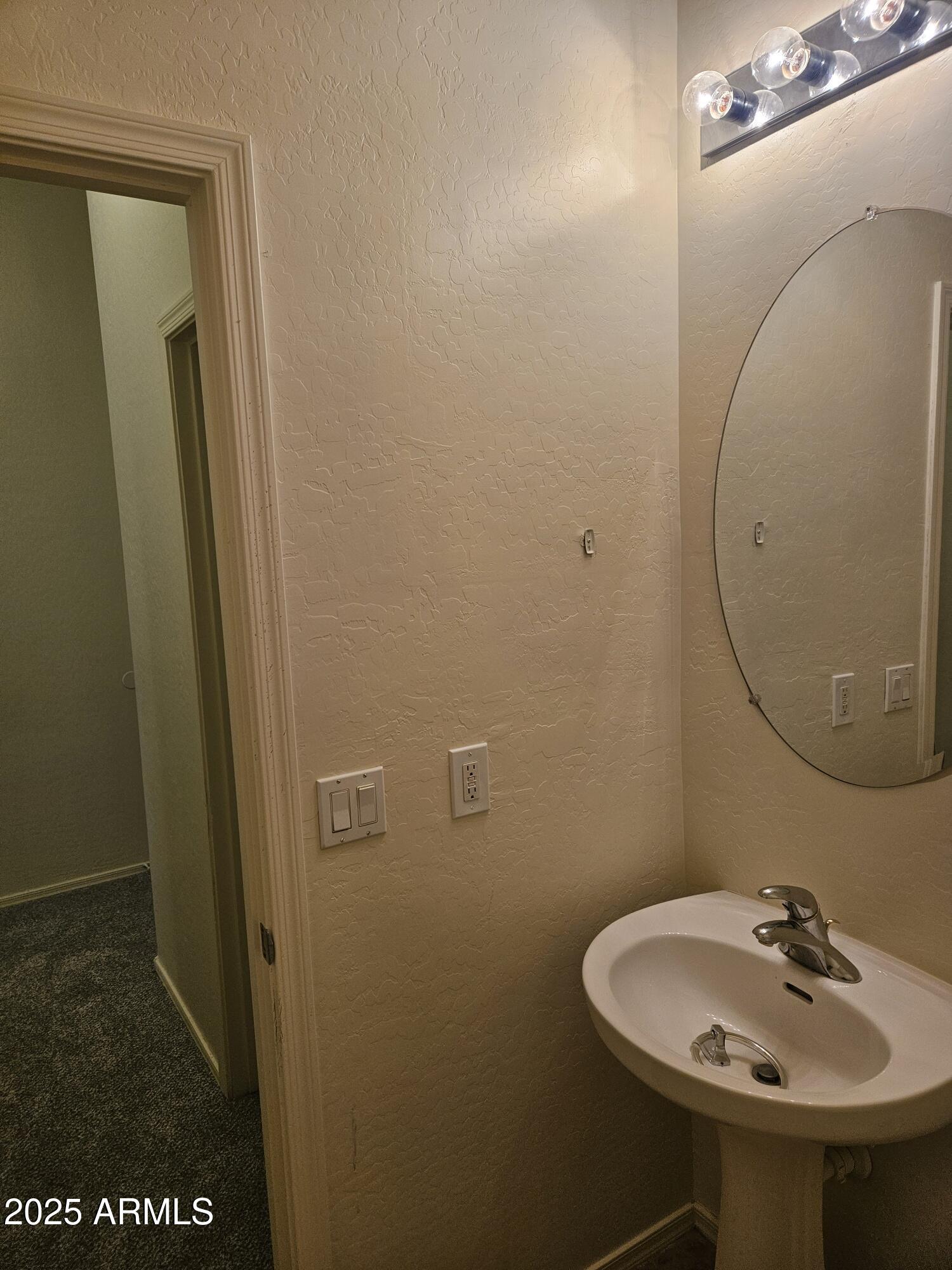 4692 South Calico Road Gilbert, AZ 85297 - Photo 23 of 29 a bathroom with a sink a toilet and a mirror