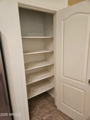 a view of walk in closet with empty racks