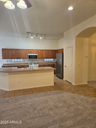 a view of kitchen with refrigerator cabinets