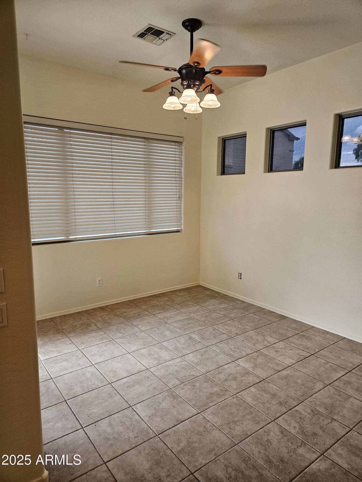 4692 South Calico Road Gilbert, AZ 85297 - Photo 8 of 29 a view of a livingroom with a chandelier fan and windows