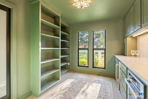 a spacious bedroom with a bed and a window