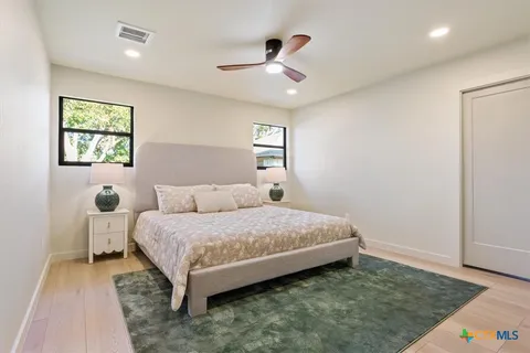 a bedroom with a bed and a window