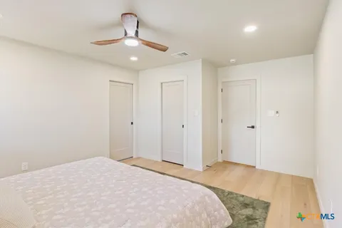 a spacious bathroom with a sink and a mirror