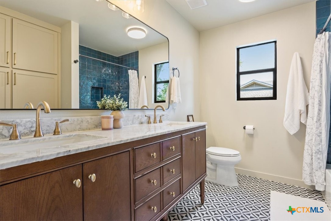4306 Spanish Oak Road Temple, TX 76502 - Photo 27 of 36 a bathroom with a sink a toilet and a mirror