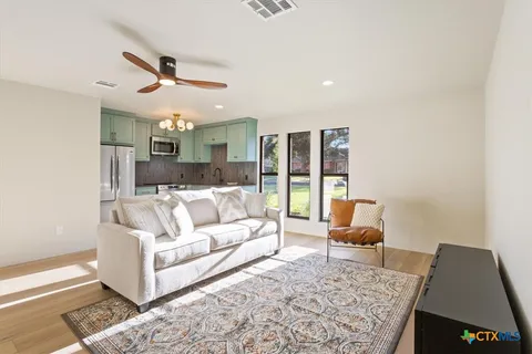 a kitchen with stainless steel appliances granite countertop a refrigerator a stove a sink and dishwasher