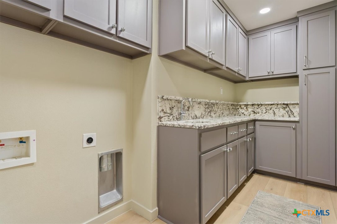 4306 Spanish Oak Road Temple, TX 76502 - Photo 31 of 36 a kitchen with stainless steel appliances granite countertop a sink a stove and cabinets