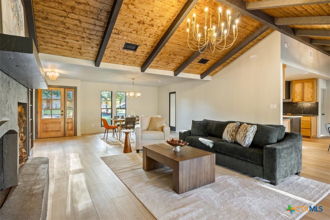 4306 Spanish Oak Road Temple, TX 76502 - Photo 6 of 36 a living room with furniture a fireplace and gym equipment