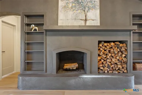 a living room with a fireplace and a large window