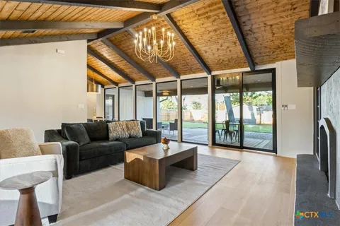 a living room with furniture and a floor to ceiling window