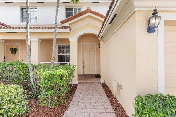 a view of a house with potted plants