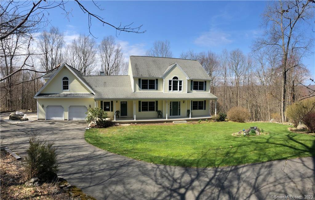 a front view of a house with a garden and trees