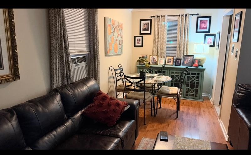 476 Jenson Road Memphis, TN 38109 - Photo 10 of 30 Living area with light wood-style flooring, ornamental molding, and cooling unit