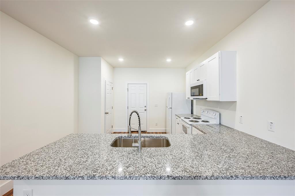 3525 Herrling Street Dallas, TX 75210 - Photo 14 of 28 a kitchen with stainless steel appliances granite countertop a sink stove and cabinets