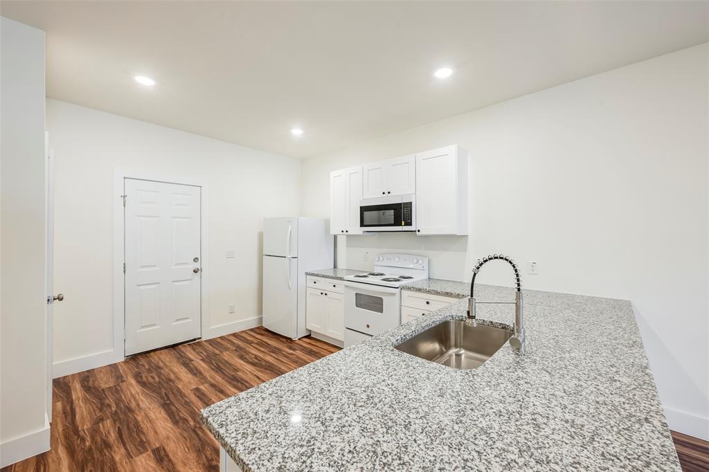 3525 Herrling Street Dallas, TX 75210 - Photo 15 of 28 a bedroom with a bed and a stove top oven