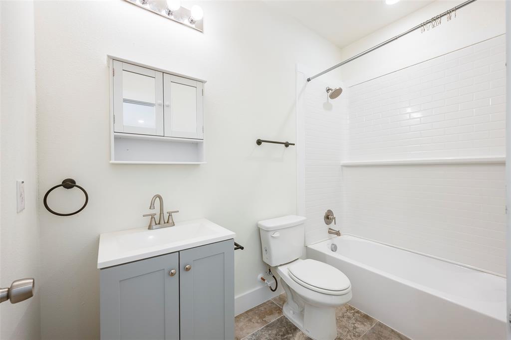 3525 Herrling Street Dallas, TX 75210 - Photo 21 of 28 a bathroom with a sink a toilet and shower