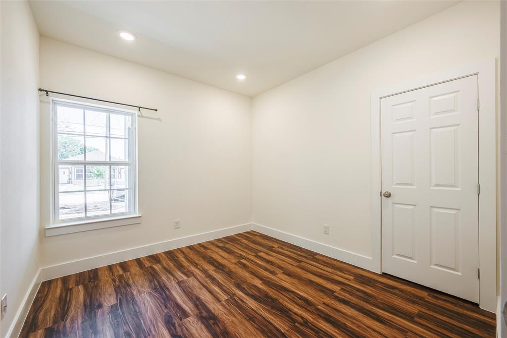 3525 Herrling Street Dallas, TX 75210 - Photo 25 of 28 an empty room with wooden floor and windows