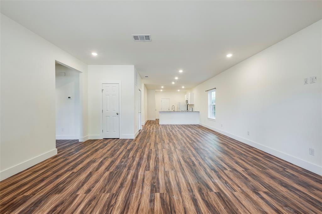 3525 Herrling Street Dallas, TX 75210 - Photo 7 of 28 a view of a room with wooden floor and electronic appliances