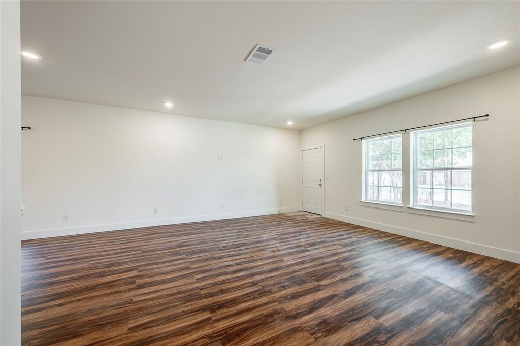 3525 Herrling Street Dallas, TX 75210 - Photo 8 of 28 wooden floor in an empty room with a window
