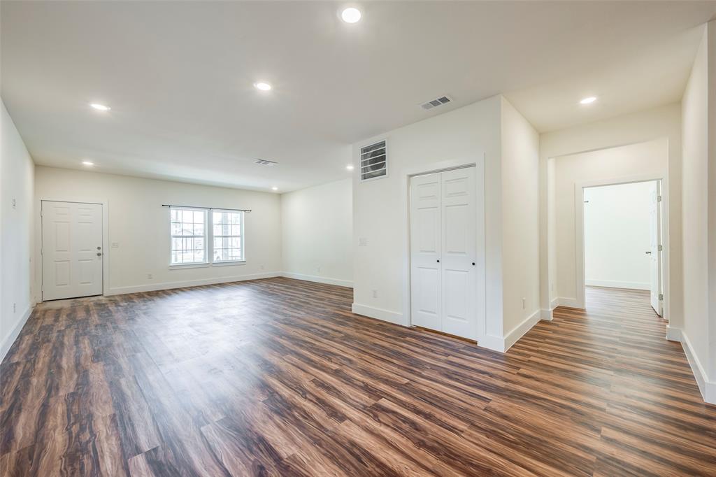 3525 Herrling Street Dallas, TX 75210 - Photo 9 of 28 a view of an empty room with wooden floor and a window