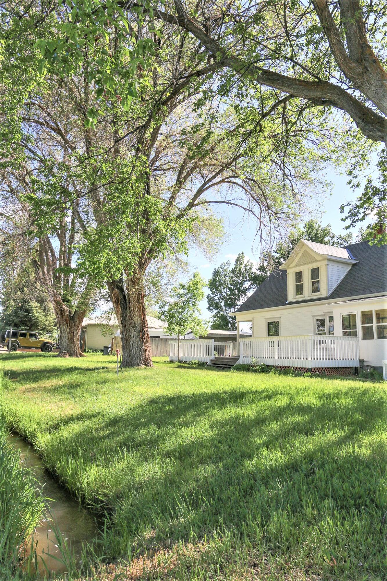 34537 3575th Road Redvale, CO 81431 - Photo 5 of 23 a view of a big yard next to a house with a big yard and large trees