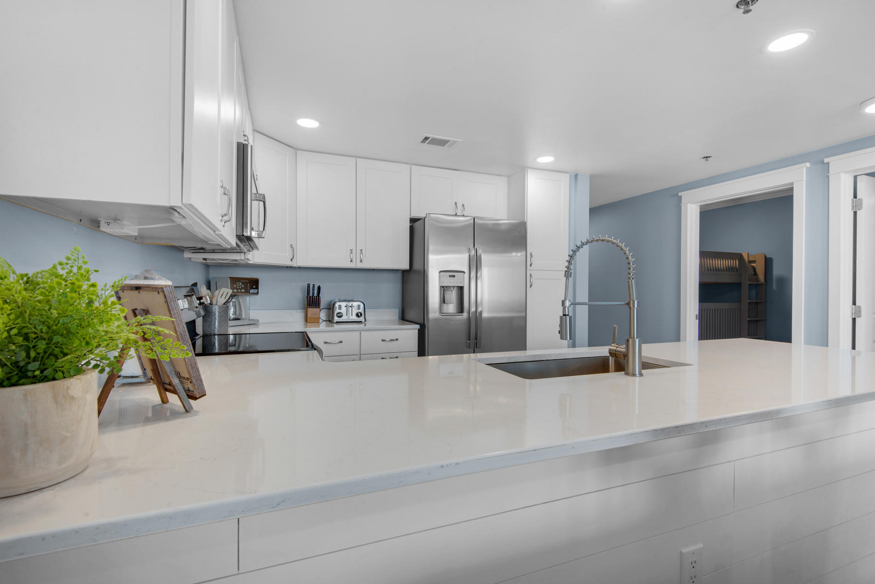 1110 Santa Rosa Boulevard, Unit B501 Fort Walton Beach, FL 32548 - Photo 15 of 51 a kitchen with stainless steel appliances kitchen island granite countertop a refrigerator and a sink