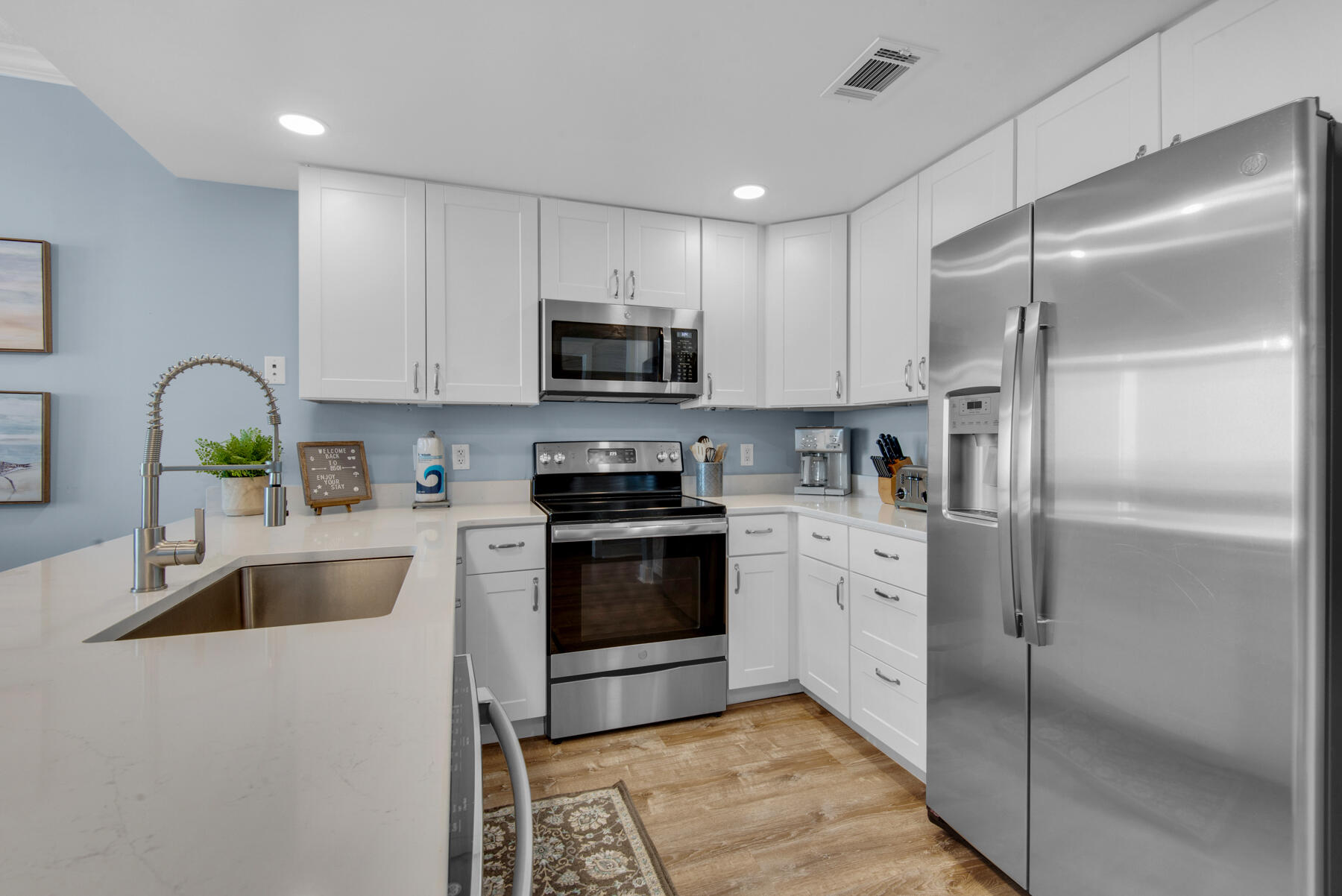 1110 Santa Rosa Boulevard, Unit B501 Fort Walton Beach, FL 32548 - Photo 16 of 51 a kitchen with stainless steel appliances granite countertop a refrigerator a stove a sink and a microwave