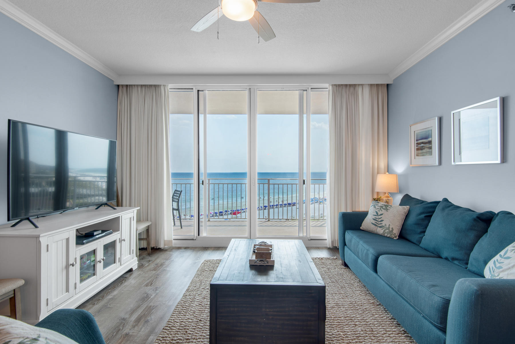 1110 Santa Rosa Boulevard, Unit B501 Fort Walton Beach, FL 32548 - Photo 8 of 51 a living room with furniture a flat screen tv and a floor to ceiling window
